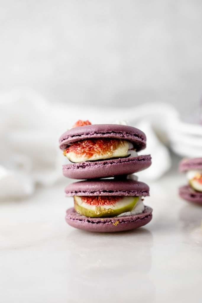 Fresh fig and vanilla bean French macarons. A delicious flavor combination for the fall season! Perfect for autumn celebrations and gatherings. Recipe and assembly video.