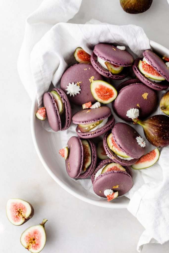 Fresh fig and vanilla bean French macarons. A delicious flavor combination for the fall season! Perfect for autumn celebrations and gatherings. Recipe and assembly video.
