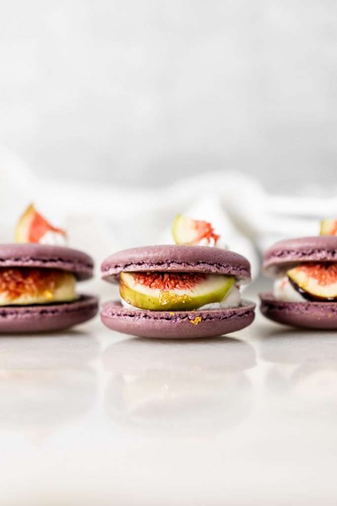 Fresh fig and vanilla bean French macarons. A delicious flavor combination for the fall season! Perfect for autumn celebrations and gatherings. Recipe and assembly video.