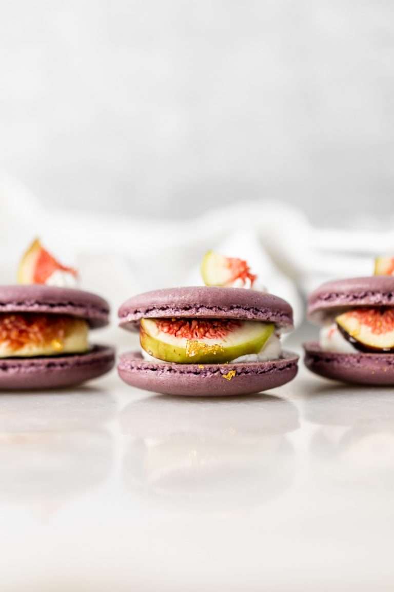 Fresh fig and vanilla bean French macarons. A delicious flavor combination for the fall season! Perfect for autumn celebrations and gatherings. Recipe and assembly video.