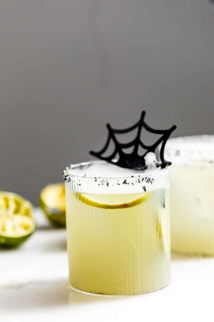 A quick and easy smoked margarita recipe perfect for halloween, made with mezcal and served on the rocks!