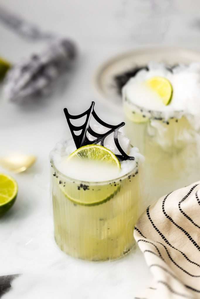 A quick and easy smoked margarita recipe perfect for halloween, made with mezcal and served on the rocks!