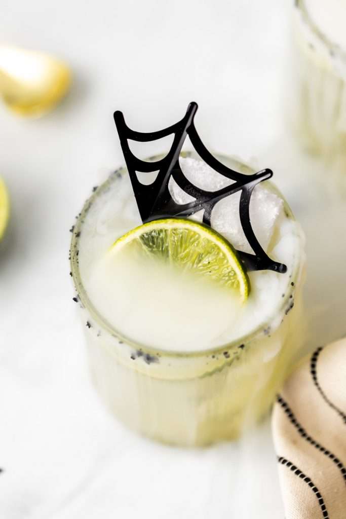 A quick and easy smoked margarita recipe perfect for halloween, made with mezcal and served on the rocks!