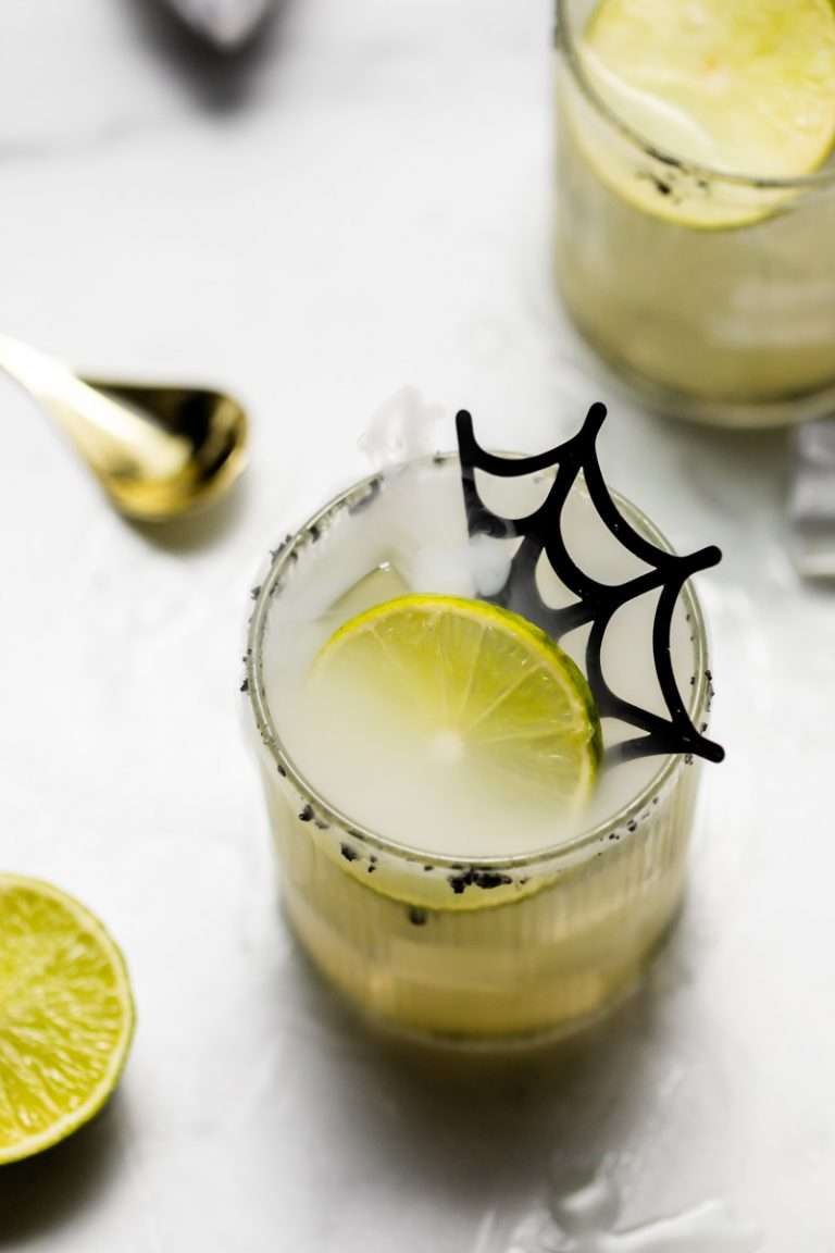 A quick and easy smoked margarita recipe perfect for halloween, made with mezcal and served on the rocks!