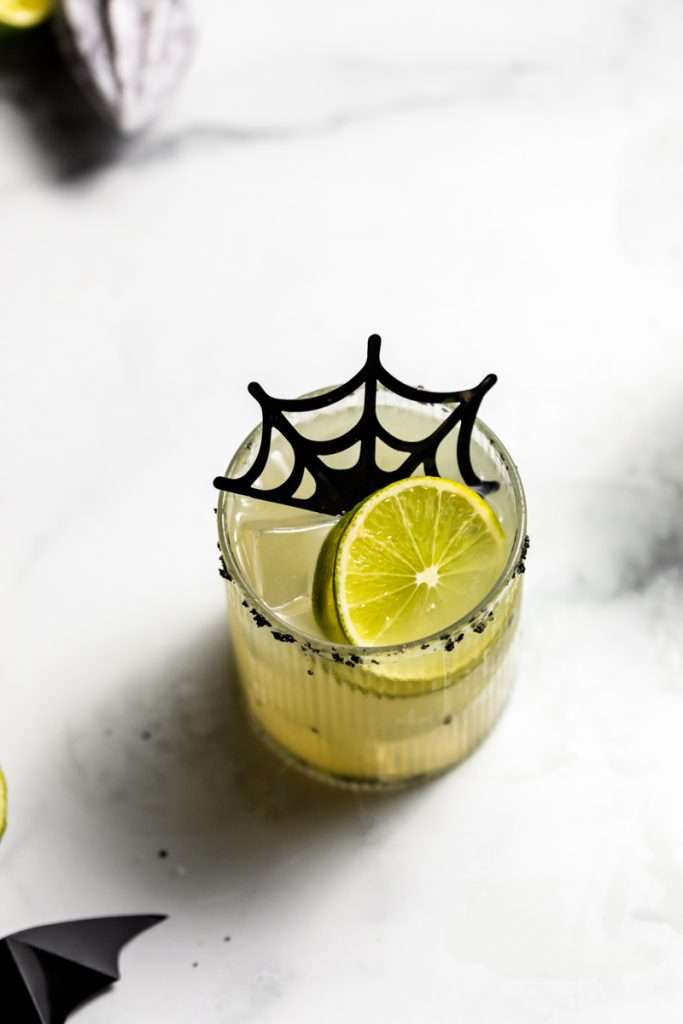 A quick and easy smoked margarita recipe perfect for halloween, made with mezcal and served on the rocks!