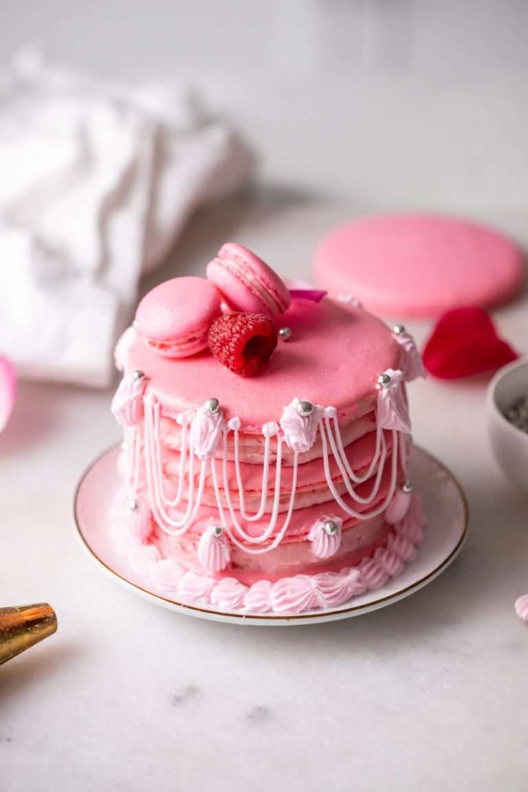 Marie Antoinette ispahan inspired macaron cake with fresh raspberries, raspberry rose frosting and royal icing decorations. The perfect party treat with recipe and video!