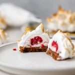 Baked Alaska Macarons, with a chocolate macaron shell base, raspberry ice cream core, topped with torched Italian meringue. A modern bite-sized spin on the classic Baked Alaska dessert. Dairy Free & Gluten Free