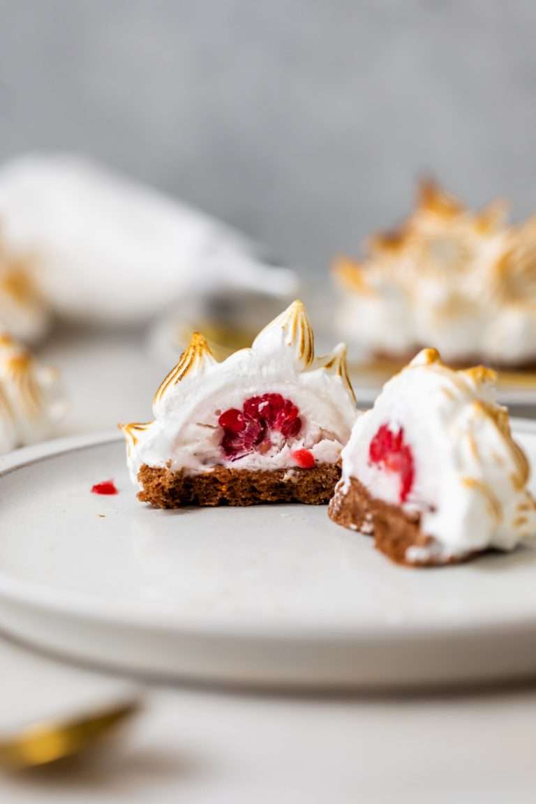 Baked Alaska Macarons, with a chocolate macaron shell base, raspberry ice cream core, topped with torched Italian meringue. A modern bite-sized spin on the classic Baked Alaska dessert. Dairy Free & Gluten Free
