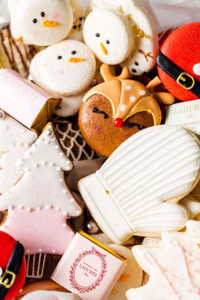 An elegant box of Christmas cookies with macarons, sugar cookies and more in shades of pink. Year in review