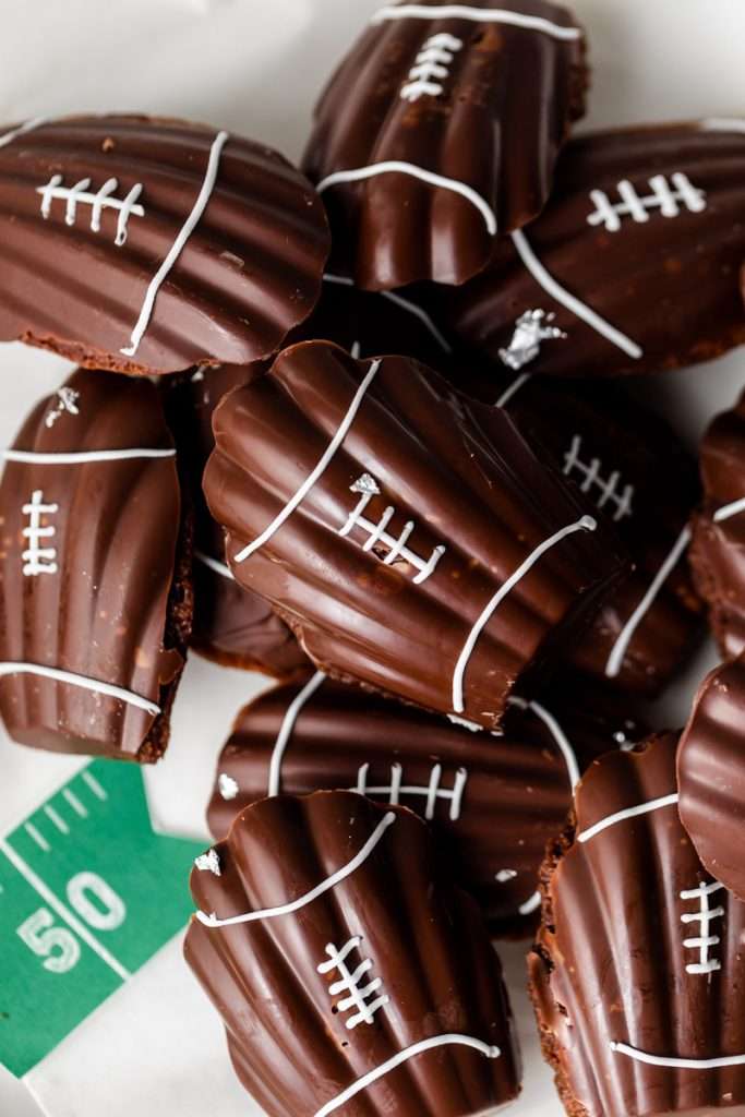A recipe for chocolate French madeleines, coated in dark chocolate and decorated to look like footballs for Super Bowl Sunday or any football theme. Dairy and Gluten free option available!
