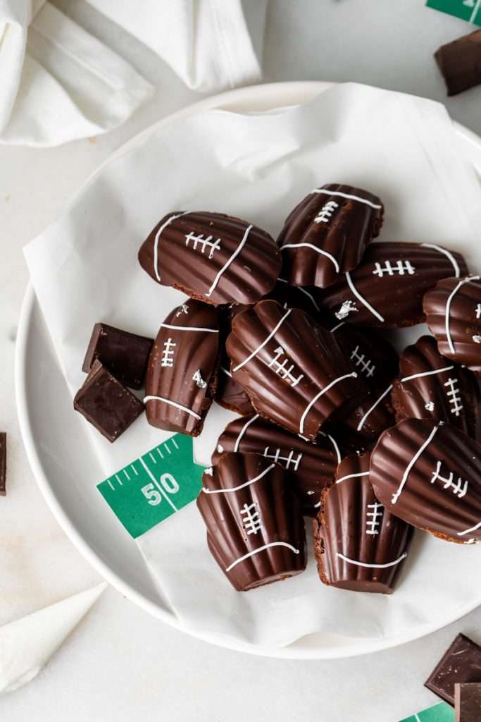 A recipe for chocolate French madeleines, coated in dark chocolate and decorated to look like footballs for Super Bowl Sunday or any football theme. Dairy and Gluten free option