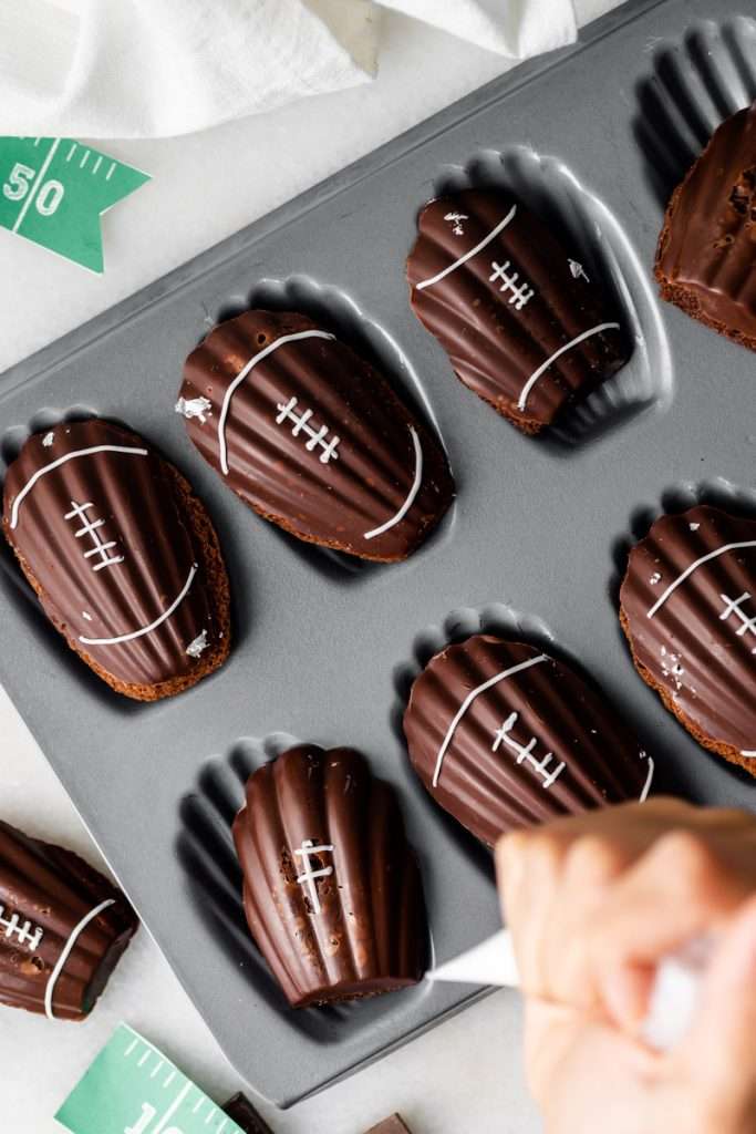 A recipe for chocolate French madeleines, coated in dark chocolate and decorated to look like footballs for Super Bowl Sunday or any football theme. Dairy and Gluten free option