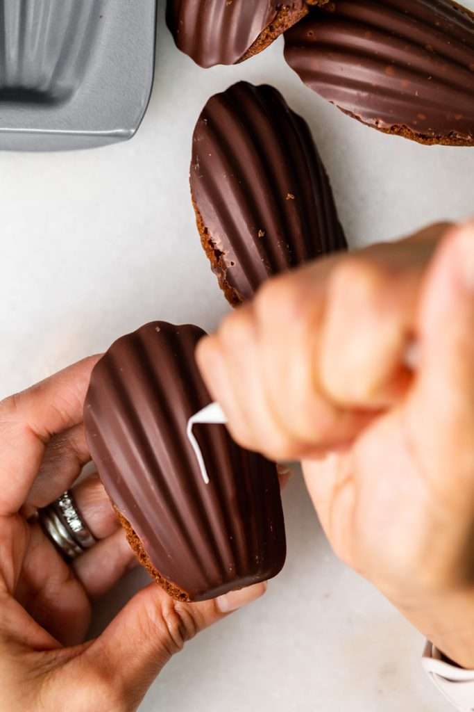 A recipe for chocolate French madeleines, coated in dark chocolate and decorated to look like footballs for Super Bowl Sunday or any football theme. Dairy and Gluten free option