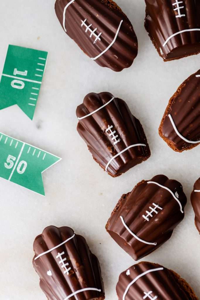A recipe for chocolate French madeleines, coated in dark chocolate and decorated to look like footballs for Super Bowl Sunday or any football theme. Dairy and Gluten free option