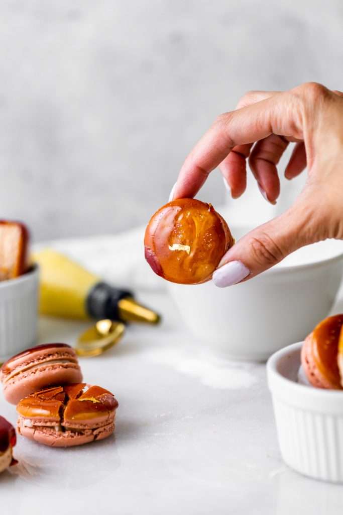 Créme brûlée macarons inspired by trendy crème brûlée donuts, complete with a creamy vanilla custard center and a crisp caramelized dipped shell. A dairy free and gluten free macaron recipe. Enjoy with tea, coffee, or champagne.