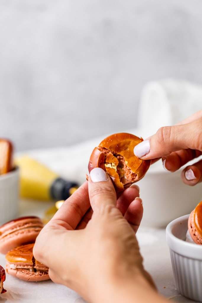 Créme brûlée macarons inspired by trendy crème brûlée donuts, complete with a creamy vanilla custard center and a crisp caramelized dipped shell. A dairy free and gluten free macaron recipe. Enjoy with tea, coffee, or champagne.