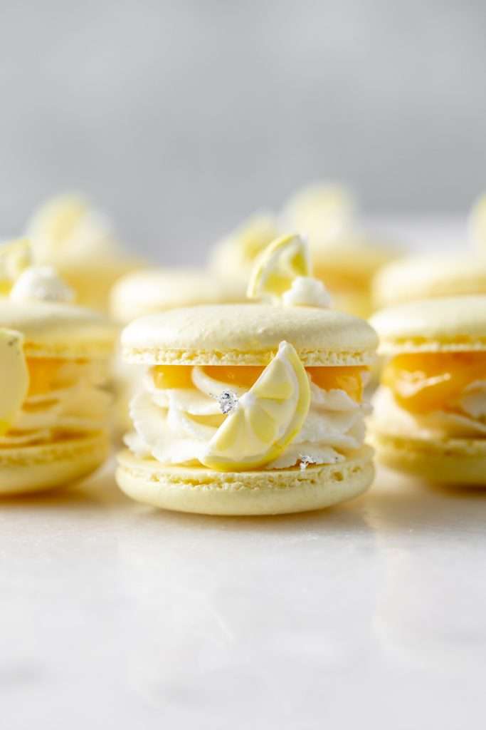 Lemon Curd French Macarons filled with lemon vanilla bean filling and citrusy lemon curd, a delicious macaron pairing of tart and sweet perfect for any occasion. The recipe is also dairy free and gluten free.