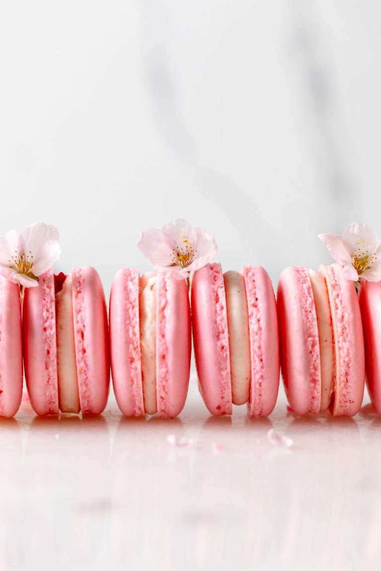 Spring macaron recipe filled with Sakura cherry blossom frosting and a fresh strawberry center. Dairy Free, Gluten Free and the perfect macaron and treat for spring.