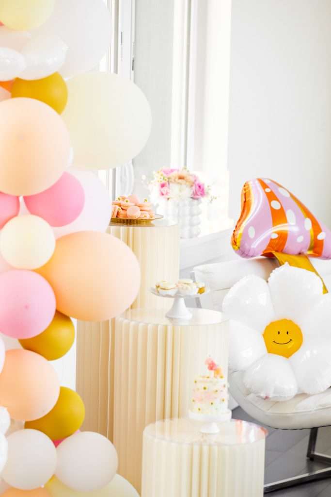 Kids retro themed birthday party with daisies, mushrooms, smiley face decor and a variety of desserts!