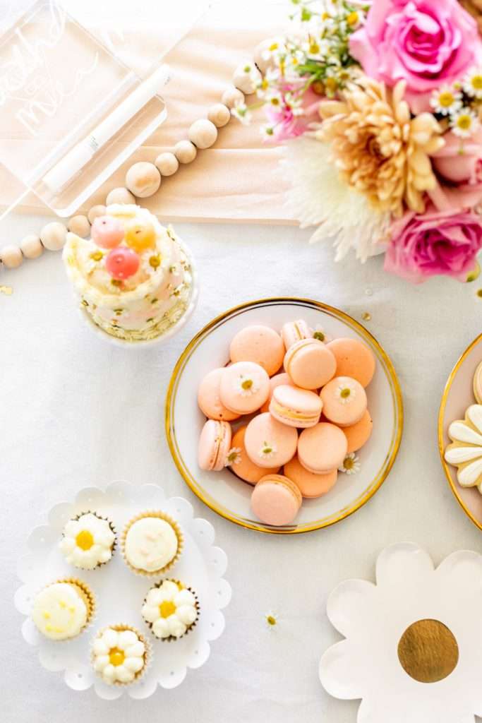 Kids retro themed birthday party desserts. Sugar cookies, macarons, cupcakes