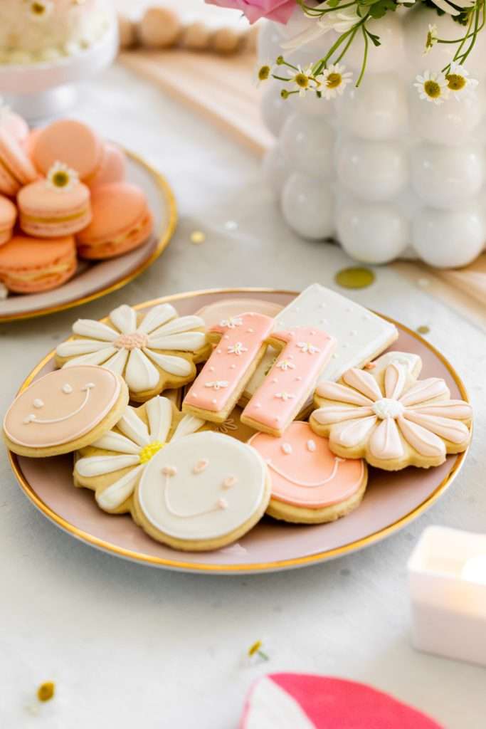 Kids retro themed birthday party desserts. Sugar cookies, macarons, cupcakes