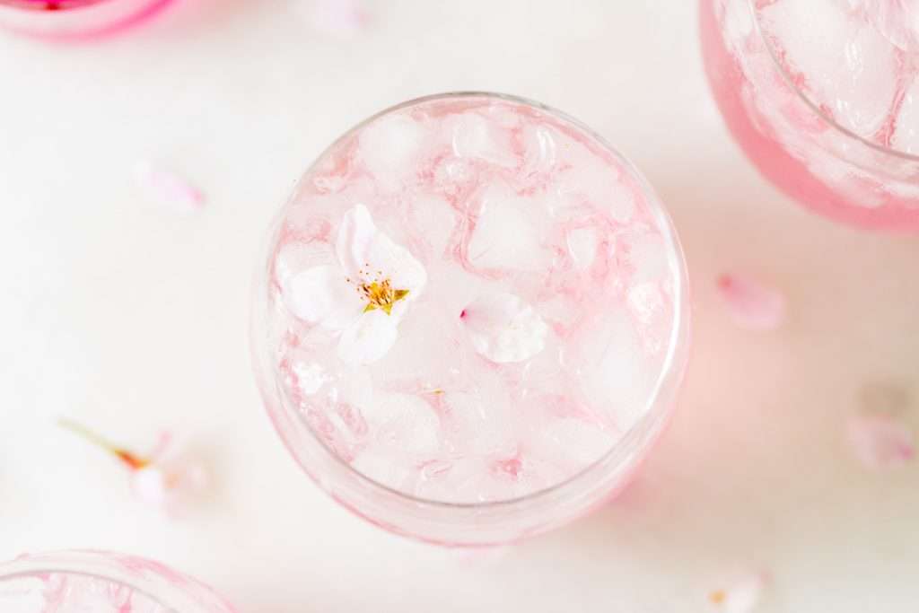 Sakura Cherry Blossom spritz cocktail! It's delicate and refreshing and the prettiest shade of pink, perfect for spring and summer parties and upcoming Mother's Day. Shake and pour over ice! Cheers