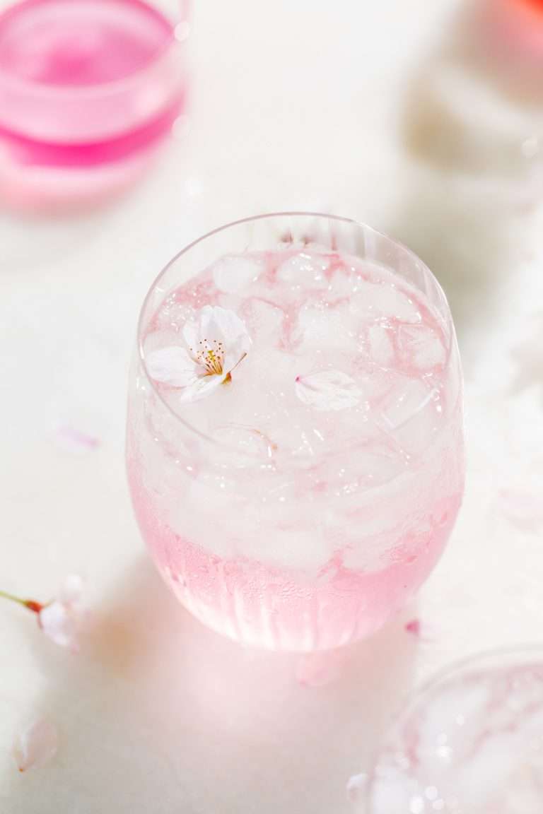 Sakura Cherry Blossom spritz cocktail! It's delicate and refreshing and the prettiest shade of pink, perfect for spring and summer parties and upcoming Mother's Day. Shake and pour over ice! Cheers