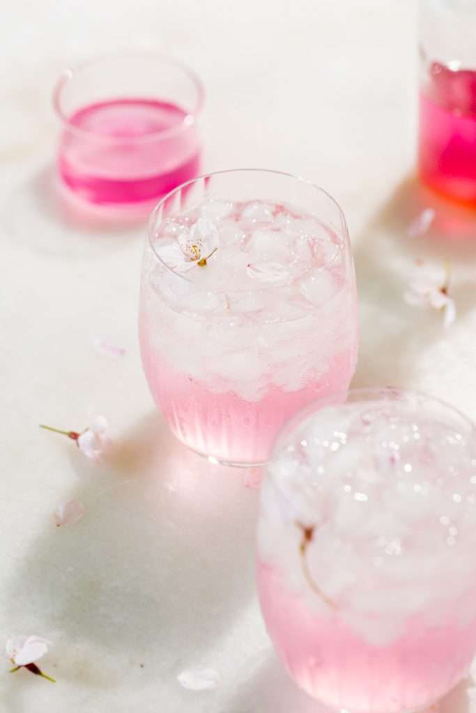 Sakura Cherry Blossom spritz cocktail! It's delicate and refreshing and the prettiest shade of pink, perfect for spring and summer parties and upcoming Mother's Day. Shake and pour over ice! Cheers
