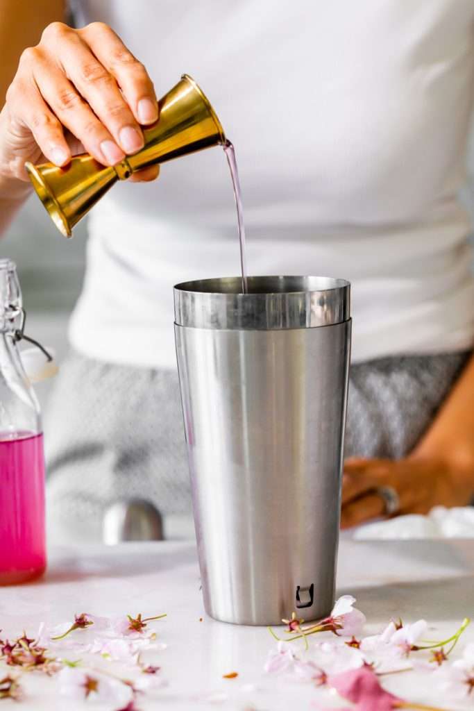 Sakura Cherry Blossom spritz cocktail! It's delicate and refreshing and the prettiest shade of pink, perfect for spring and summer parties and upcoming Mother's Day. Shake and pour over ice! Cheers
