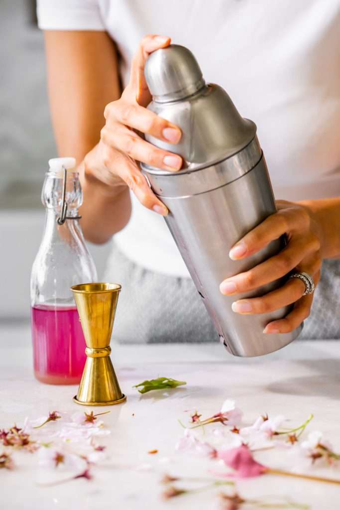 Sakura Cherry Blossom spritz cocktail! It's delicate and refreshing and the prettiest shade of pink, perfect for spring and summer parties and upcoming Mother's Day. Shake and pour over ice! Cheers