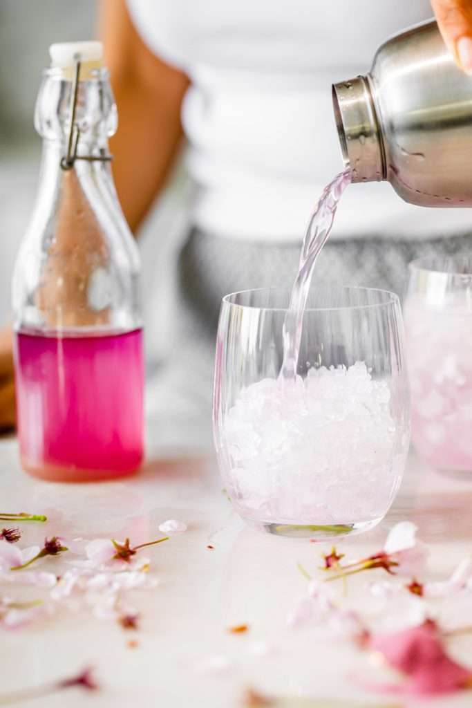 Sakura Cherry Blossom spritz cocktail! It's delicate and refreshing and the prettiest shade of pink, perfect for spring and summer parties and upcoming Mother's Day. Shake and pour over ice! Cheers