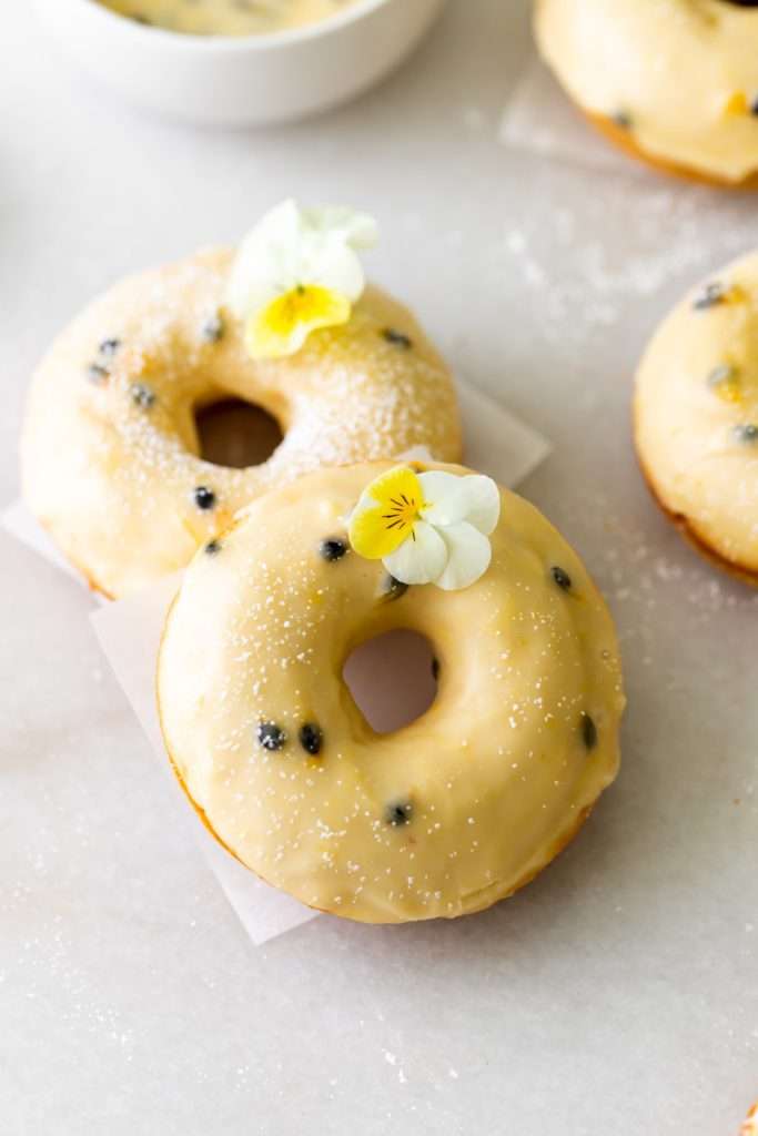 Light and fluffy small batch cake donuts covered in passion fruit glaze. Dairy free and baked not fried.