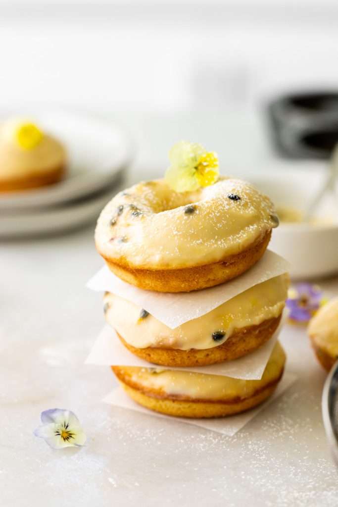 Light and fluffy small batch cake donuts covered in passion fruit glaze. Dairy free and baked not fried.