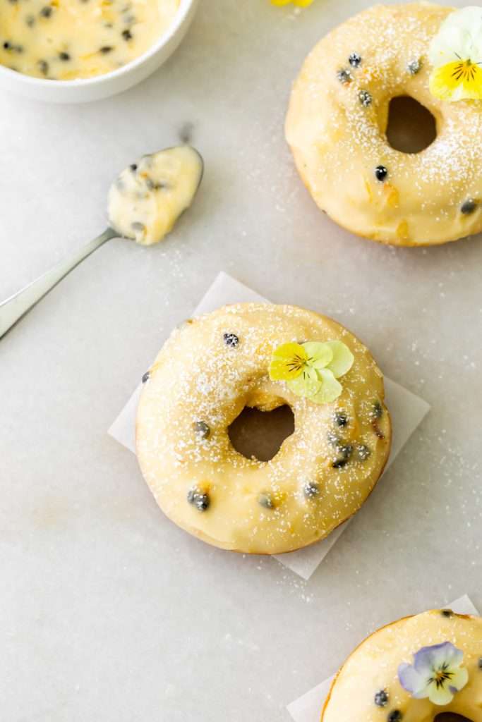 Light and fluffy small batch cake donuts covered in passion fruit glaze. Dairy free and baked not fried.
