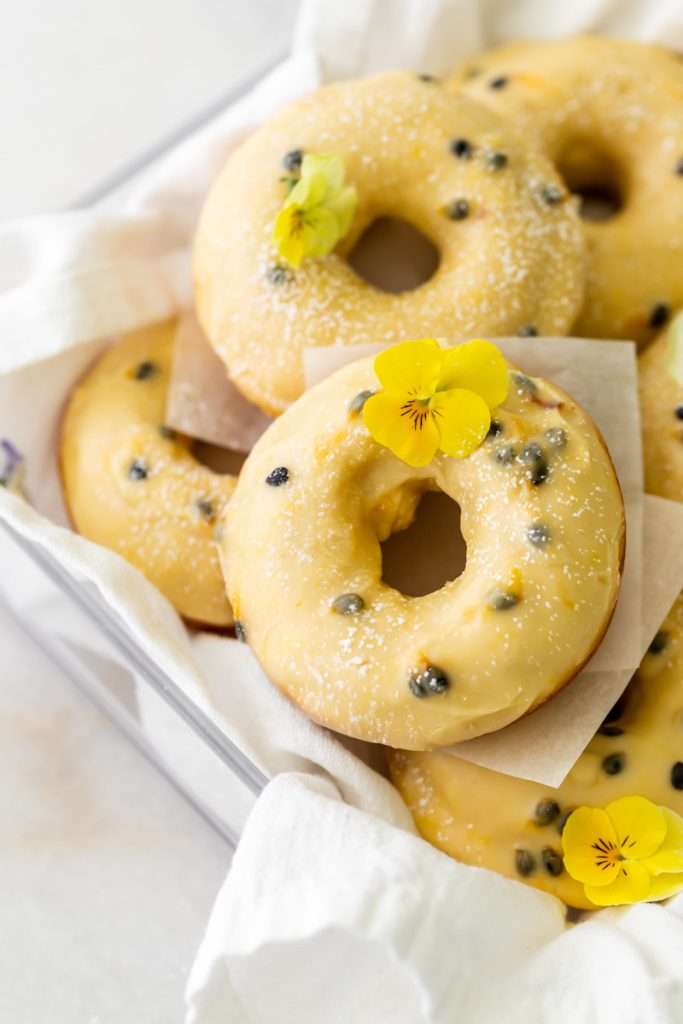 Light and fluffy small batch cake donuts covered in passion fruit glaze. Dairy free and baked not fried.