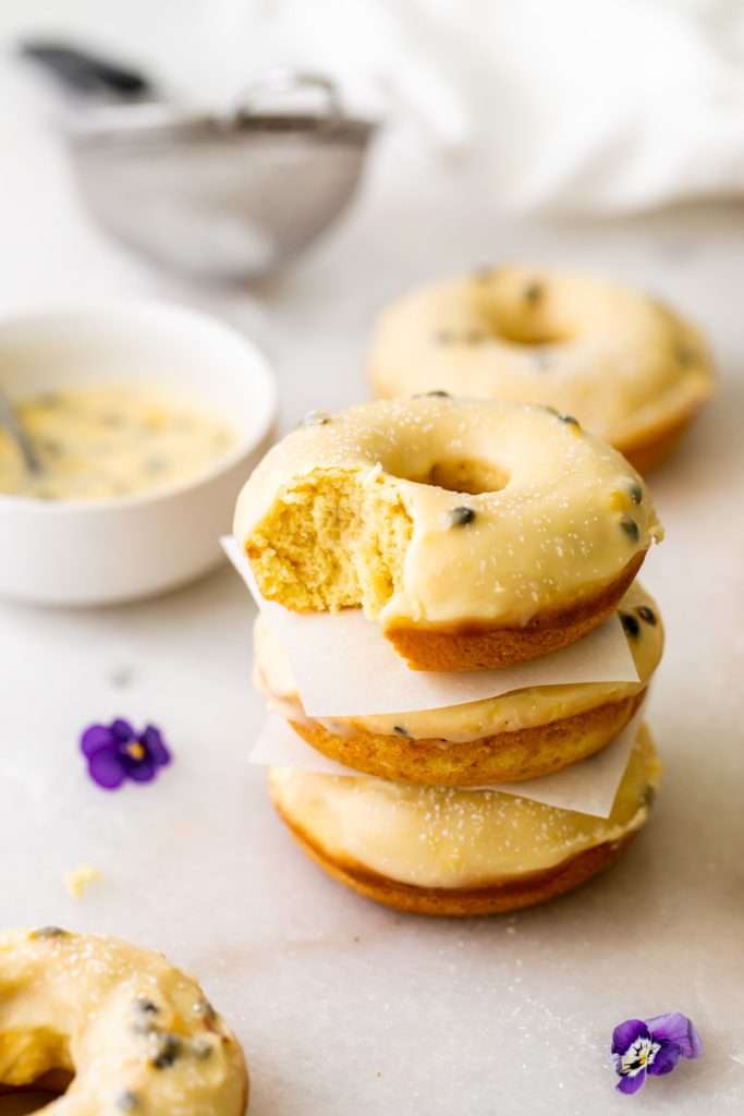 Light and fluffy small batch cake donuts covered in passion fruit glaze. Dairy free and baked not fried.