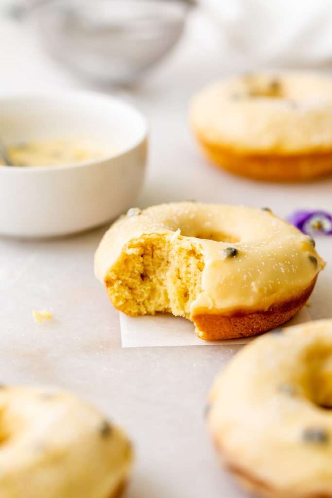 Light and fluffy small batch cake donuts covered in passion fruit glaze. Dairy free and baked not fried.