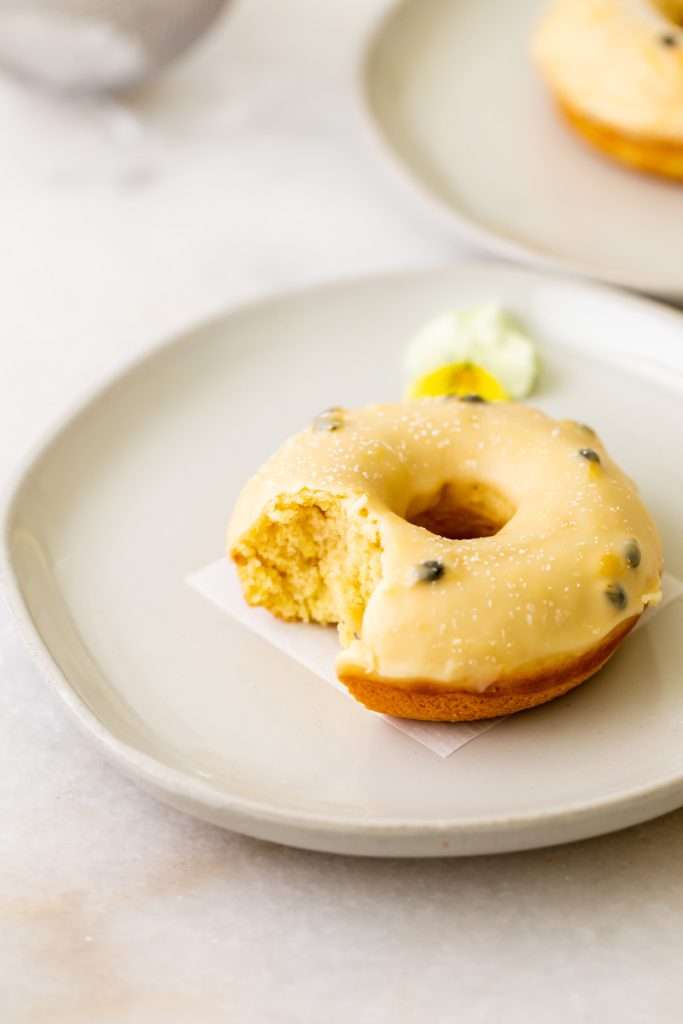 Light and fluffy small batch cake donuts covered in passion fruit glaze. Dairy free and baked not fried.