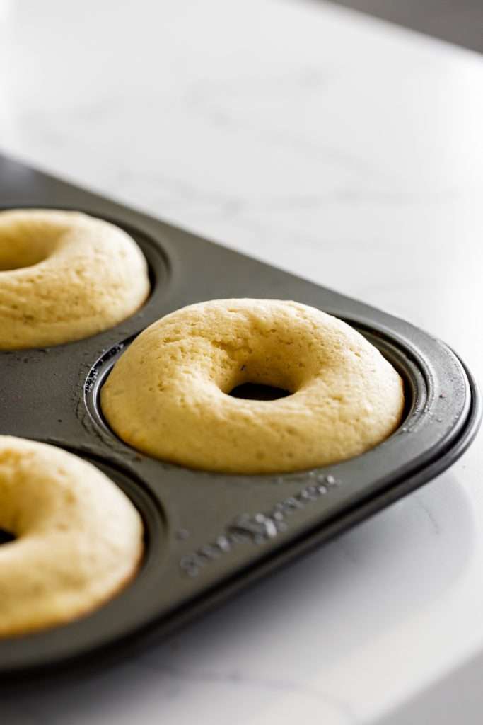 Light and fluffy small batch cake donuts covered in passion fruit glaze. Dairy free and baked not fried.