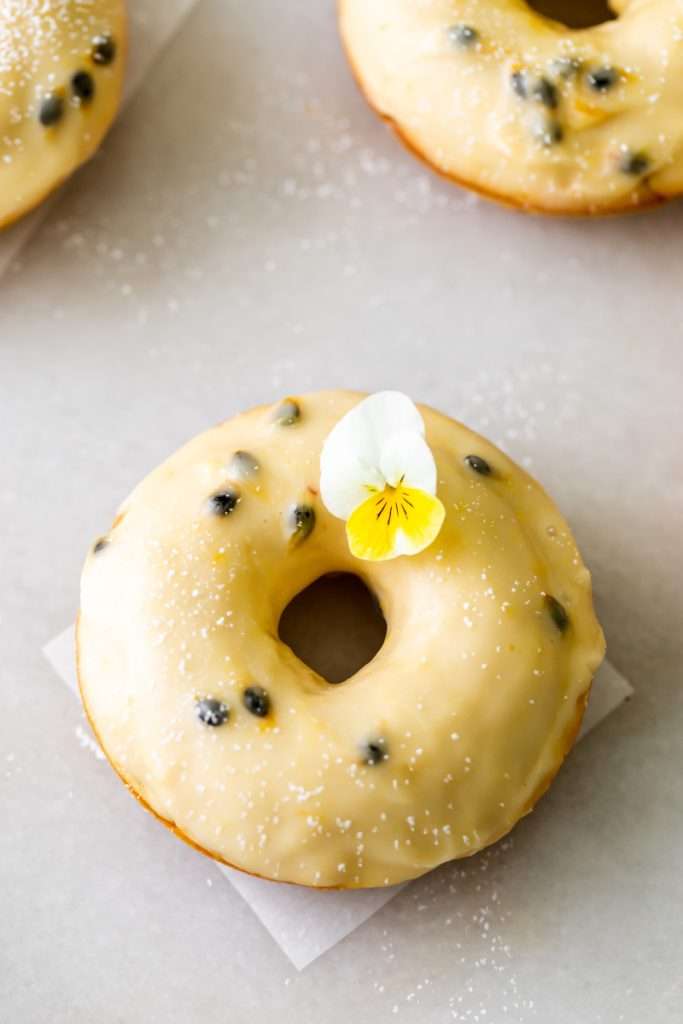 Light and fluffy small batch cake donuts covered in passion fruit glaze. Dairy free and baked not fried.