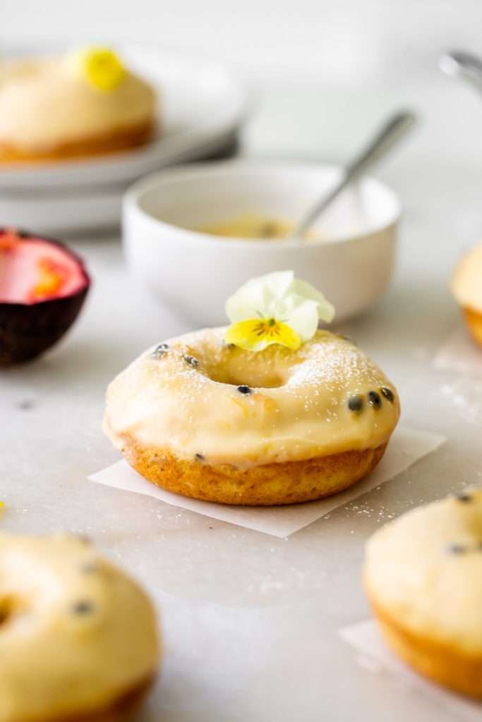 Light and fluffy small batch cake donuts covered in passion fruit glaze. Dairy free and baked not fried.