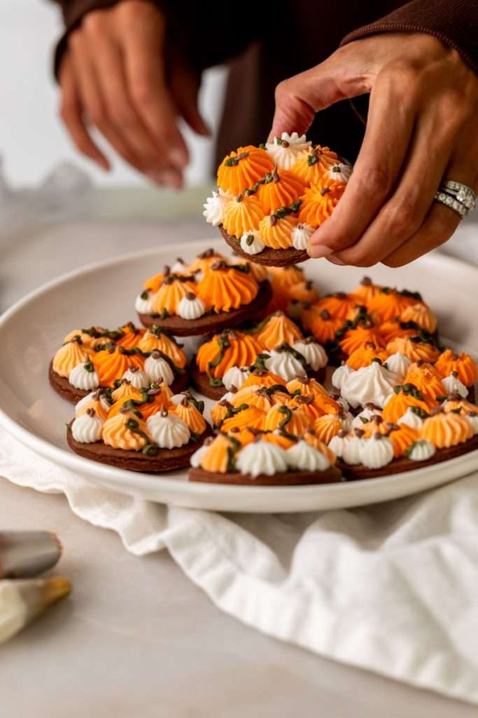 Cute chocolate cutout sugar cookies, decorated with easy pumpkin patch icing decorations. They're soft and delicious and perfect for fall gatherings, with a dairy free option included!