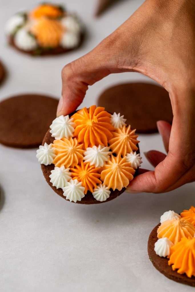 Cute chocolate cutout sugar cookies, decorated with easy pumpkin patch icing decorations. They're soft and delicious and perfect for fall gatherings, with a dairy free option included!