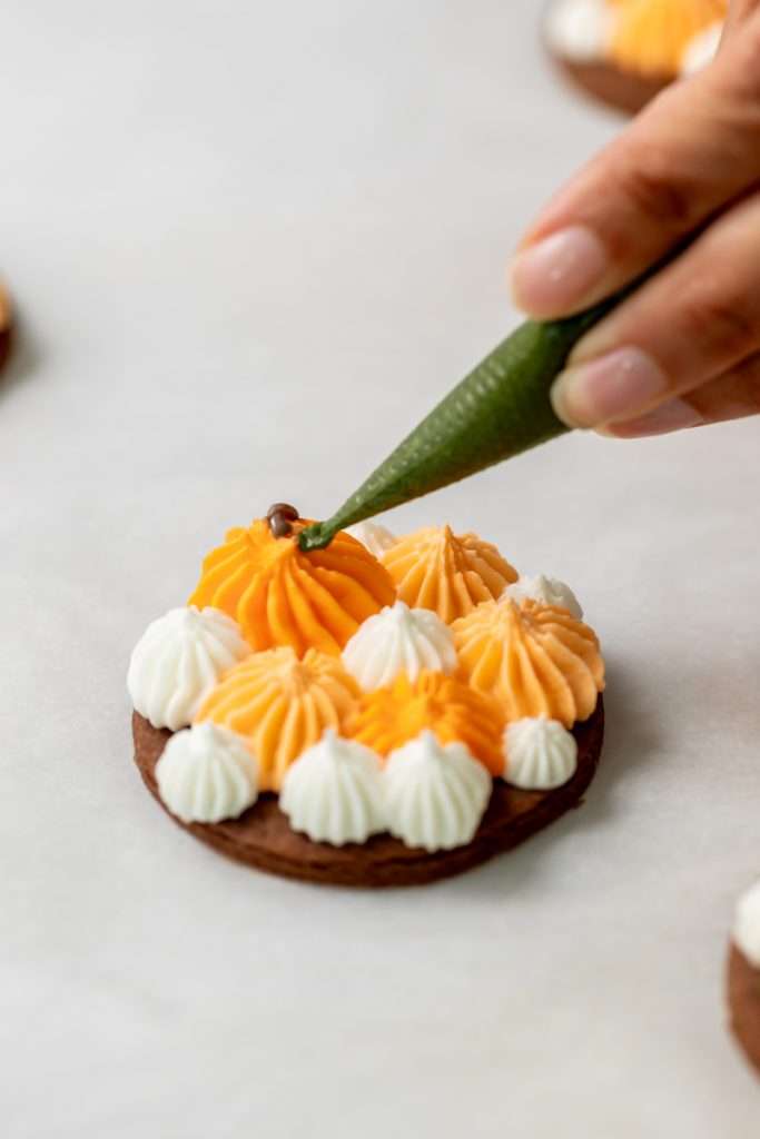 Cute chocolate cutout sugar cookies, decorated with easy pumpkin patch icing decorations. They're soft and delicious and perfect for fall gatherings, with a dairy free option included!