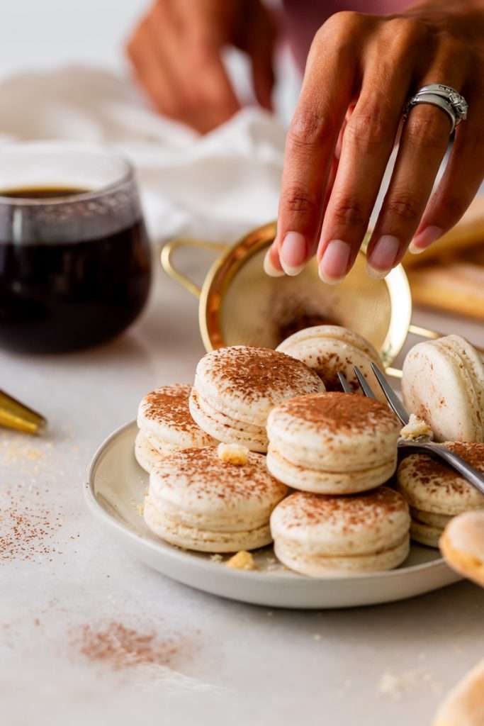 Tiramisu flavored macarons, with a tangy mascarpone filling and coffee soaked ladyfinger center. Decorated with a light dusting of cocoa powder to mimic the look of tiramisu.&nbsp;
