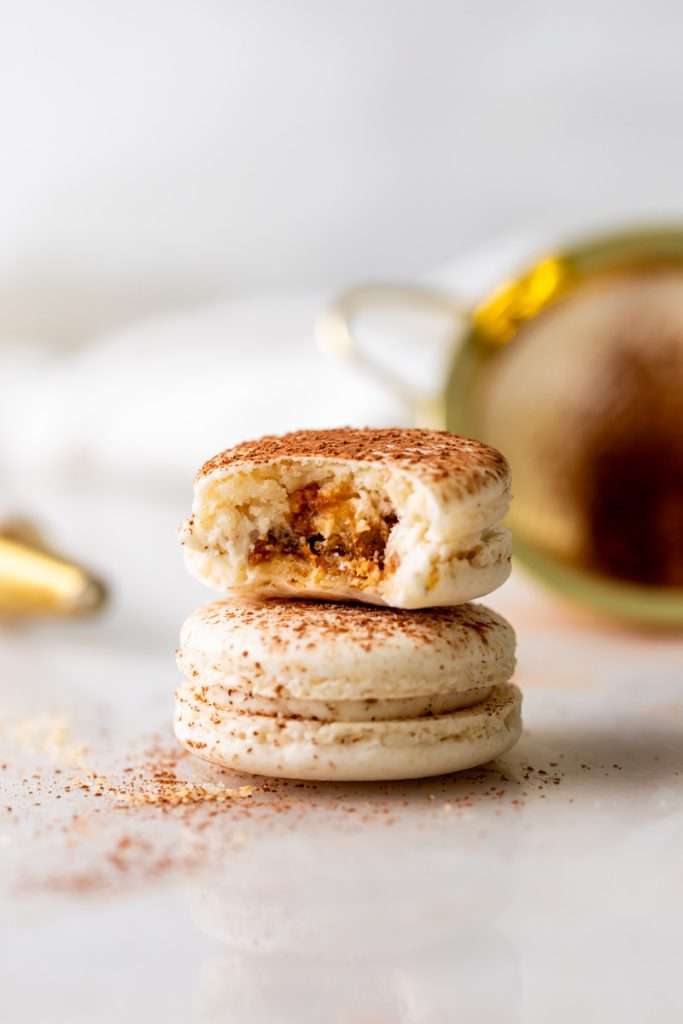 Tiramisu flavored macarons, with a tangy mascarpone filling and coffee soaked ladyfinger center. Decorated with a light dusting of cocoa powder to mimic the look of tiramisu.&nbsp;
