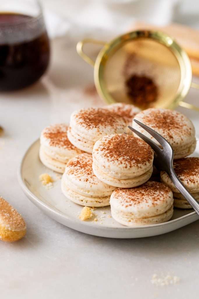 Tiramisu flavored macarons, with a tangy mascarpone filling and coffee soaked ladyfinger center. Decorated with a light dusting of cocoa powder to mimic the look of tiramisu.&nbsp;