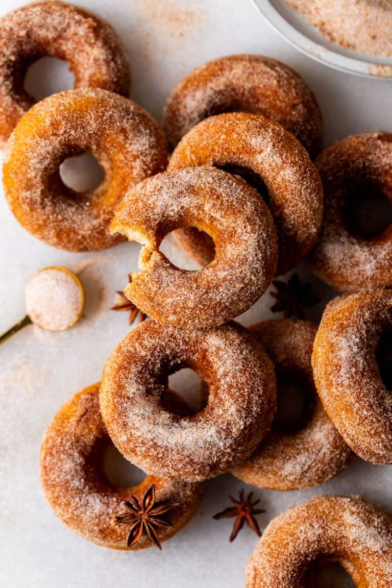 Soft and delicious baked apple cider donuts coated in cinnamon, sugar and apple cider mix topping. The easiest and most delicious donut recipe for the fall season! Dairy free.