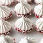 Simple and delicious peppermint meringues dipped in dark chocolate and crushed peppermint. They're dairy free, gluten free and an easy an delicious treat to share and gift during the holiday season!