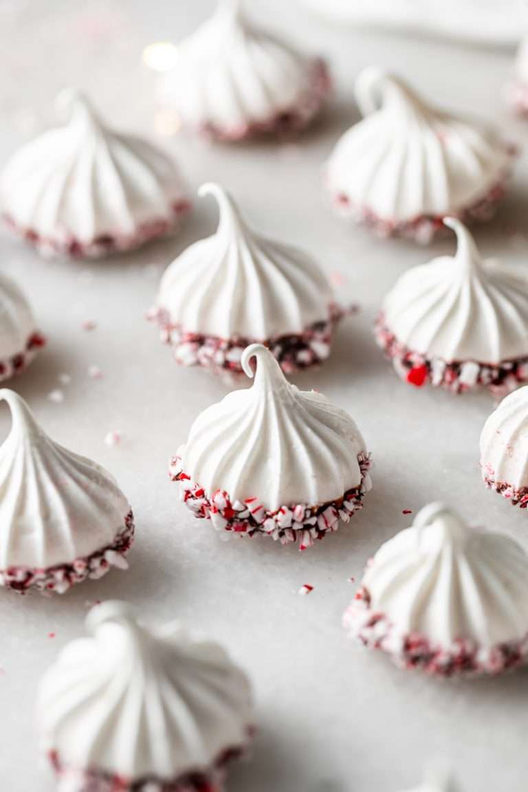 Simple and delicious peppermint meringues dipped in dark chocolate and crushed peppermint. They're dairy free, gluten free and an easy an delicious treat to share and gift during the holiday season!